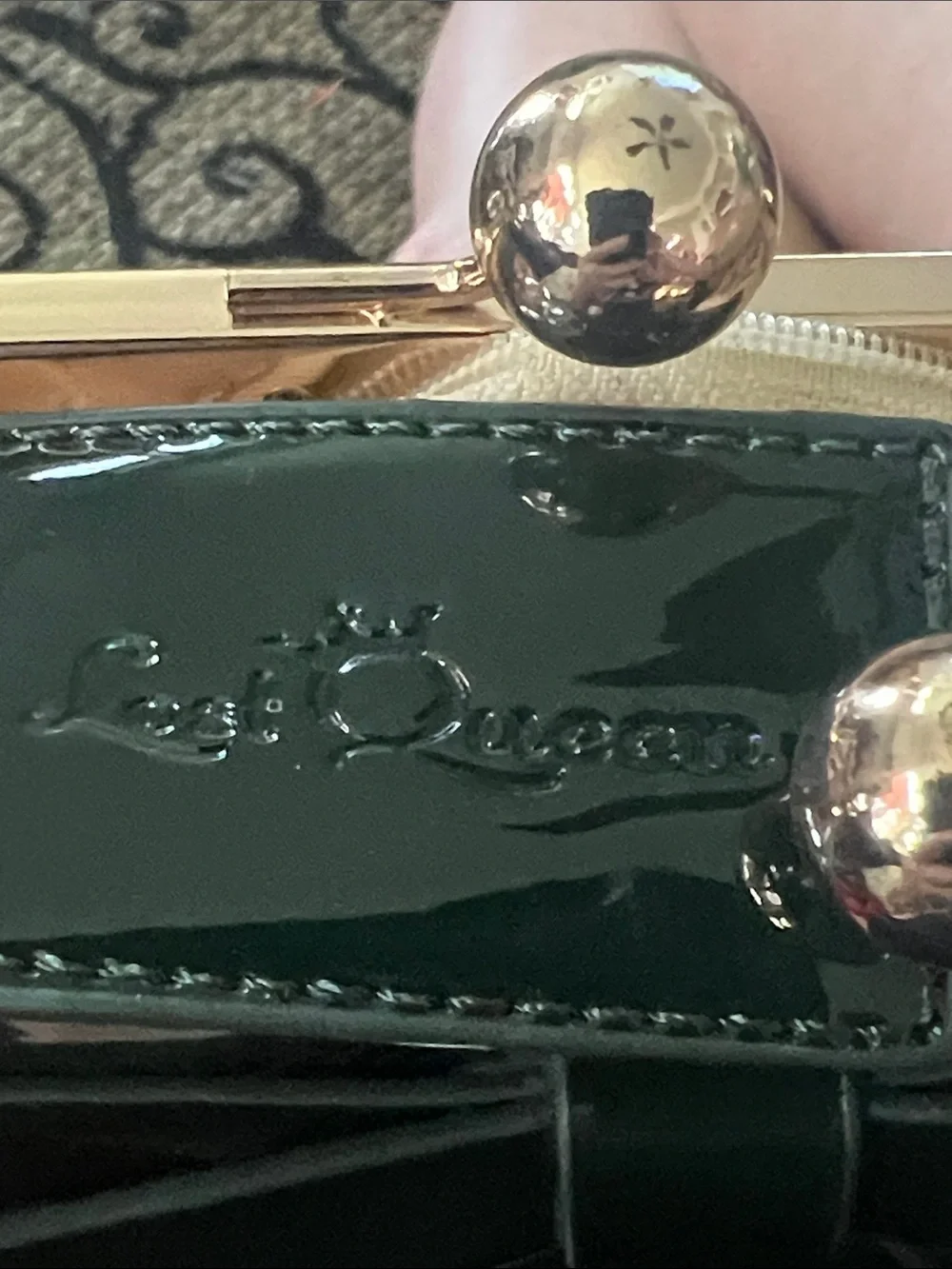 Last Queen black handbag features a patent vinyl finish